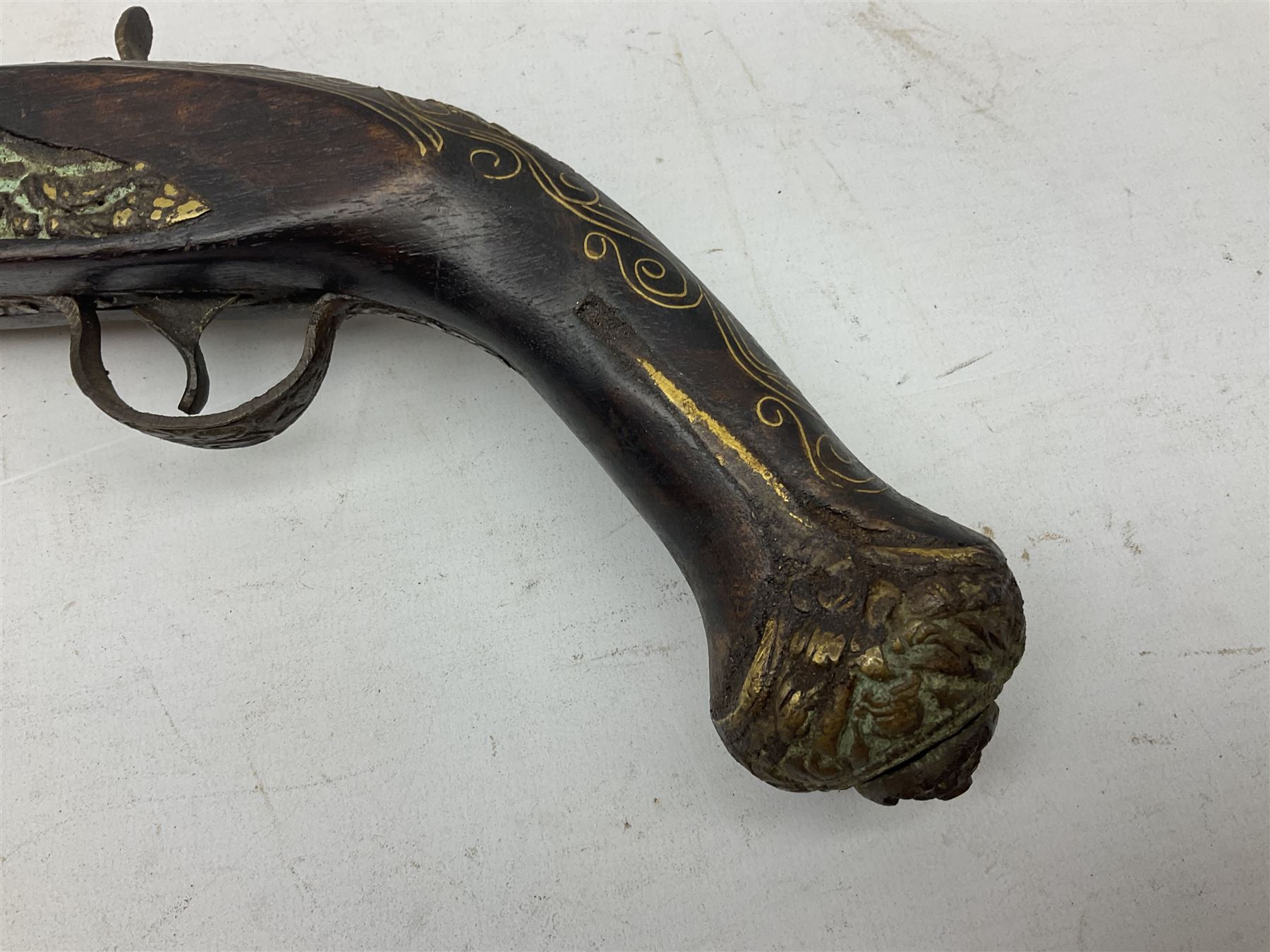 Reproduction flintlock pistol, the full walnut stock with brass filigree inlay and mounts and skull crusher butt L46cm; no visible proof marks FIREARMS CERTIFICATE REQUIRED OR RFD