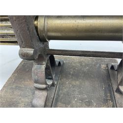 Victorian cuff and collar tabletop mangle, the ribbed brass rollers in a cast iron frame mounted on a wooden base