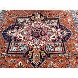 Large Persian carpet, the geometric and stylised floral medallion on rust ground field decorated with stylised plant motifs, guarded ivory border with repeating pattern