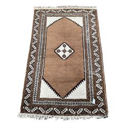 Persian rug, plain field with central lozenge, repeating patterned border
