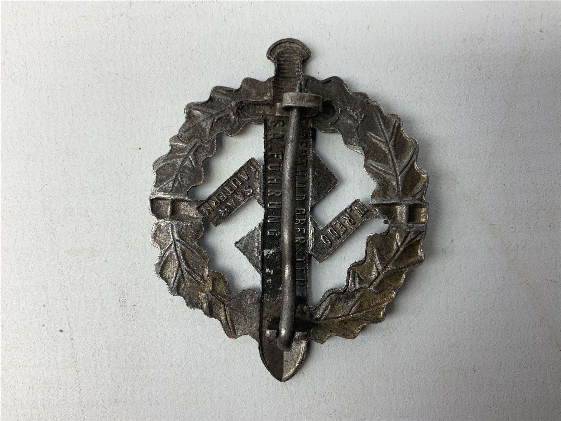 Two WW2 German Sports badges - SA sports badge marked verso 'W.Redo Eigentum D. Obersten SA. Fuhrung Saar Lautern'; and DRL sports badge marked verso 'Wernstein Jena D.R.G.M. 35269' (2)