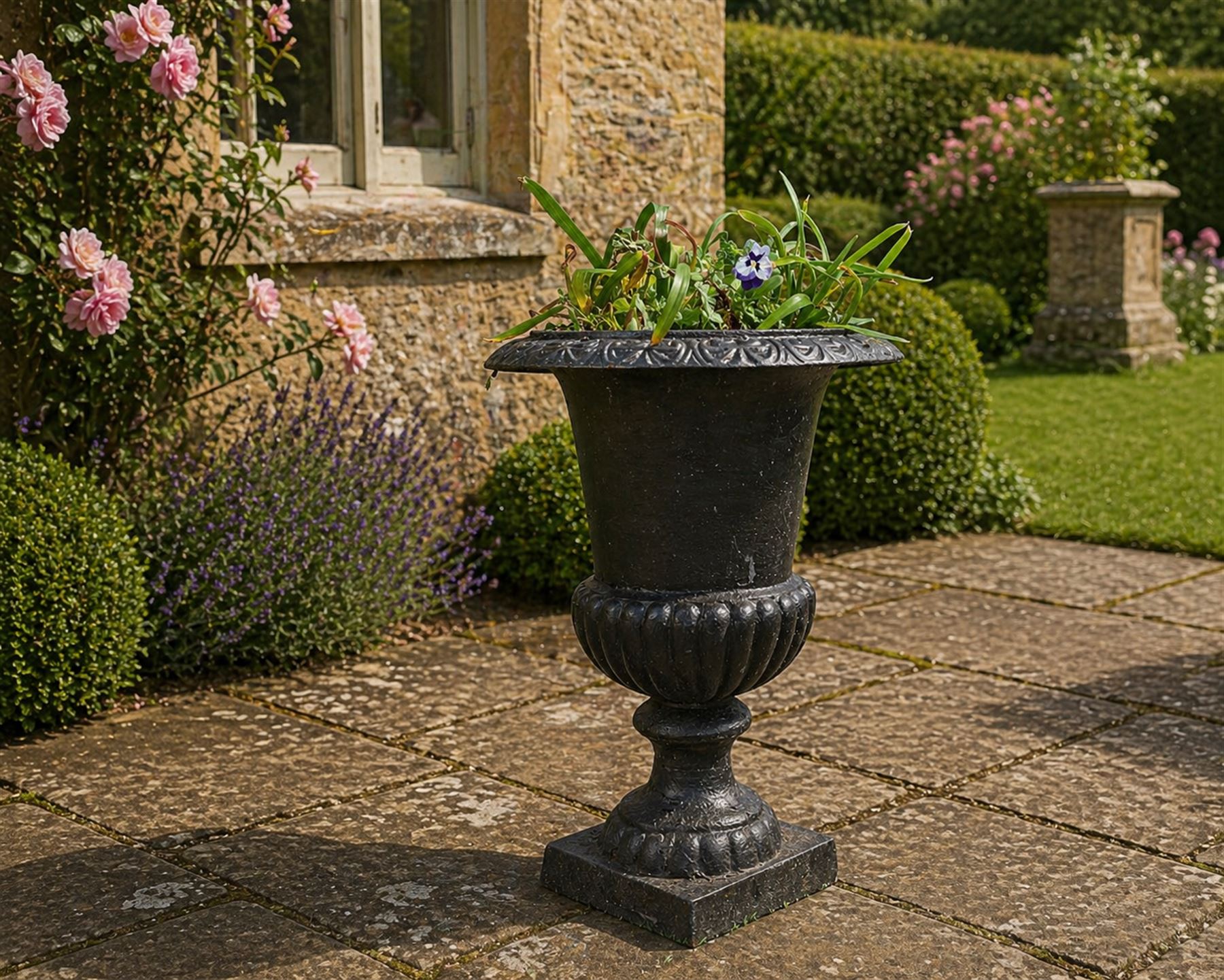 Victorian design cast iron garden centrepiece urn, egg and dart rim on tapering column, square plinth base, planted