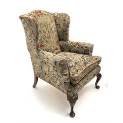 Matched pair early 20th century Queen Anne style wingback armchairs, walnut framed, sprung seats with seat cushions upholstered in needle work cover, shell carved cabriole front feet