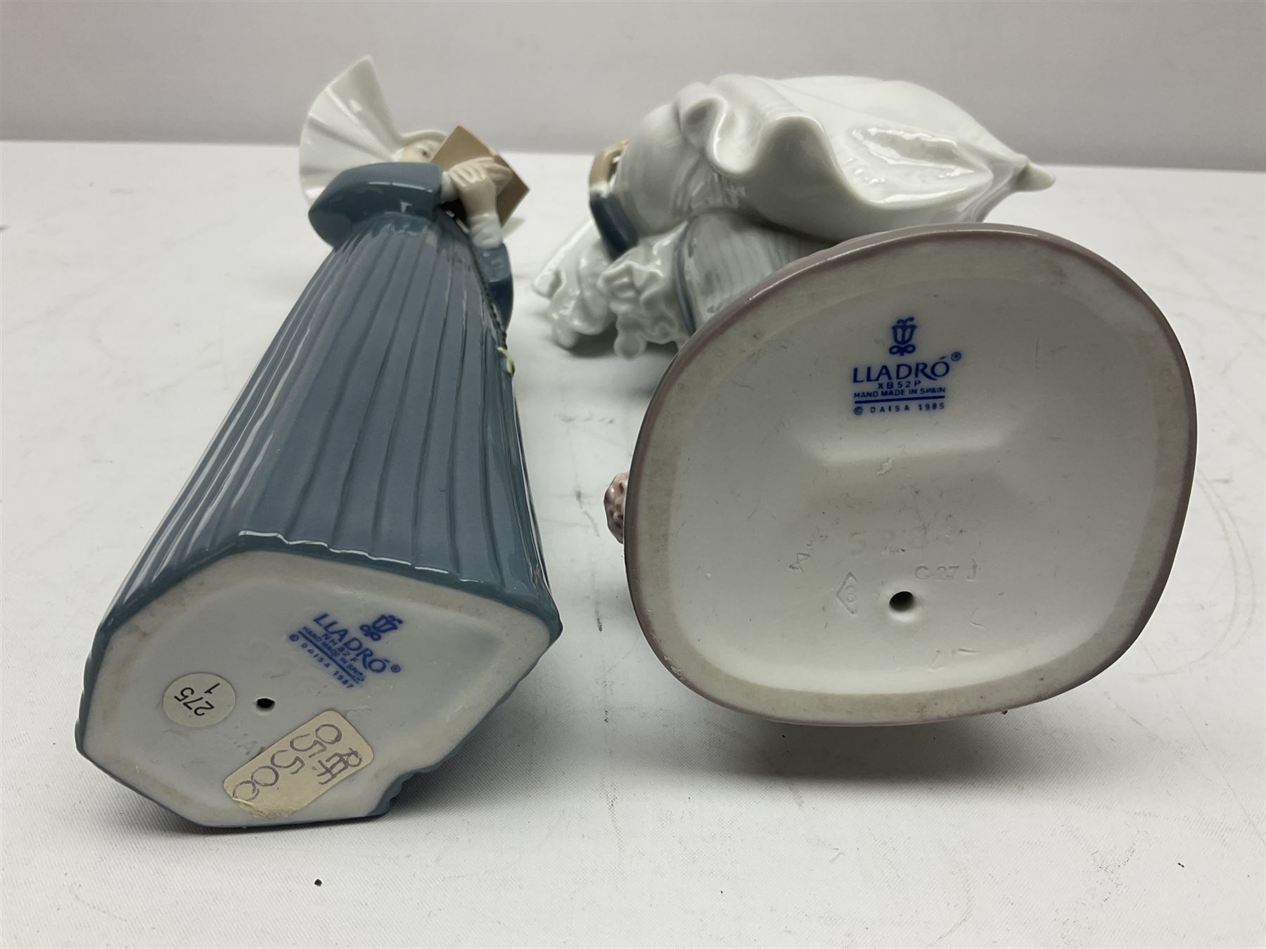 Two Lladro figures, Over the Threshold no 5282 and Prayful Moment no 5500 together with five Nao figures