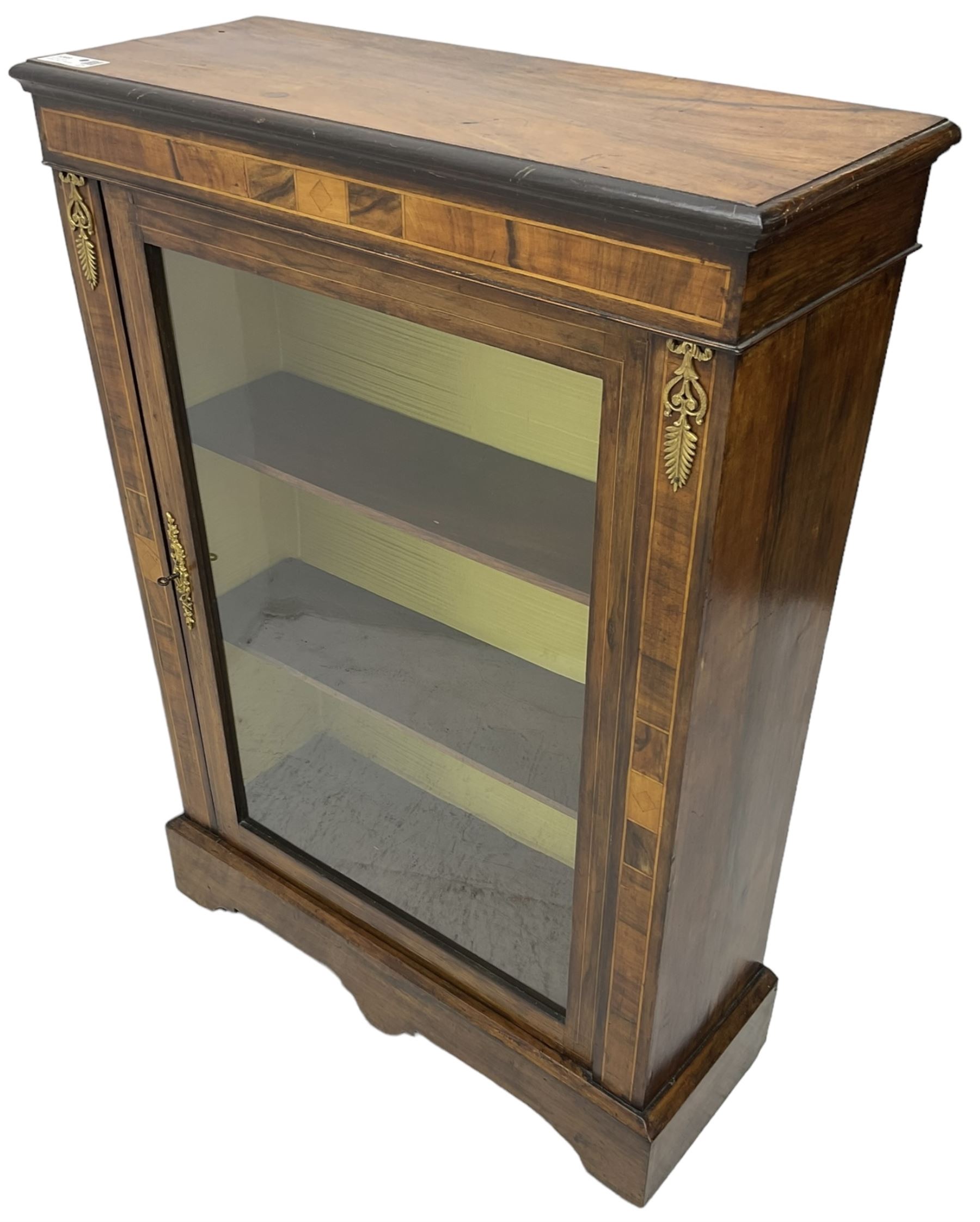 Victorian walnut pier cabinet, moulded rectangular top over inlaid frieze and uprights, enclosing by single glazed door, the interior fitted with two shelves, on shaped bracketed plinth base