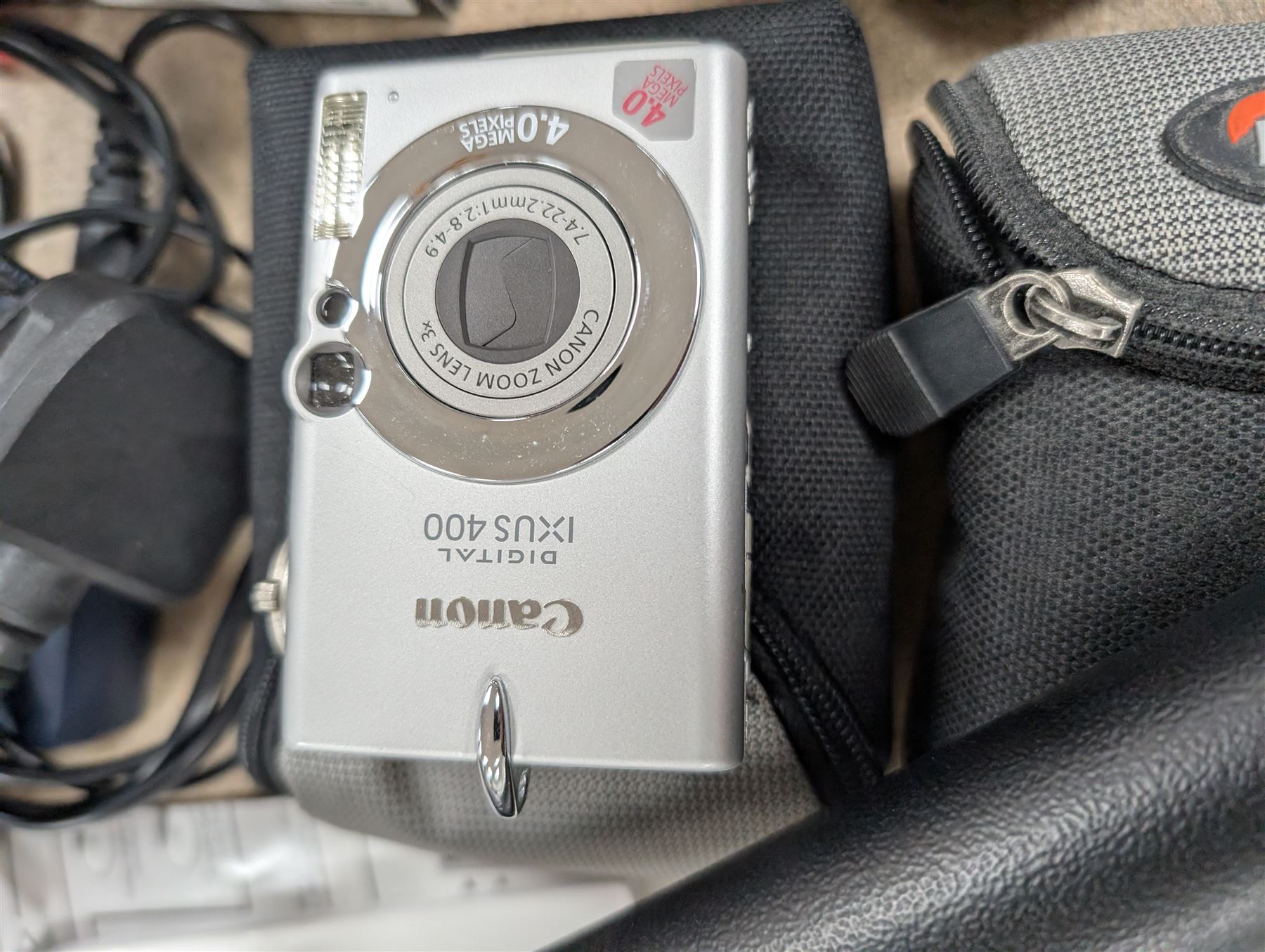 Two compact digital cameras, comprising Panasonic Lumix DMC-TZ3 digital camera, with Leica DC Vario Elmar 1:3.3-4.9/4.6-46 ASPH lens, with carry case, battery, charger, instructions and box and Canon Ixus 400 with carry case and instructions, Manfrotto Professional Tripod and a Benbo monopod