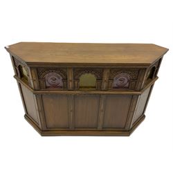 Old Charm - canted oak drinks bar, arched apertures set with mottled and bullseye colour glass panes, and three stools