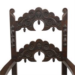 Early 20th century set of seven Jacobean Revival oak chairs, comprising pair of cavers and five chairs, each with carved mask and scroll decoration to the crest and and back rail, plain oak seat, upon turned front legs and block rear legs with conforming stretchers