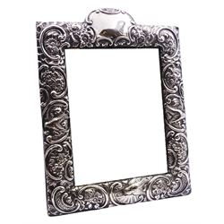Edwardian silver mounted dressing table top mirror, of rectangular form, the frame embossed with vacant reserve, birds, flower heads and C scrolls, with easel style support verso, hallmarked Walker & Hall, Sheffield 1903, overall H31.5cm W23.5cm