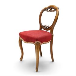 Set of five Victorian mahogany dining chairs, the scalloped balloon back with pierced scrolling acanthus leaf decoration, sprung seats upholstered in crimson fabric, on cabriole supports