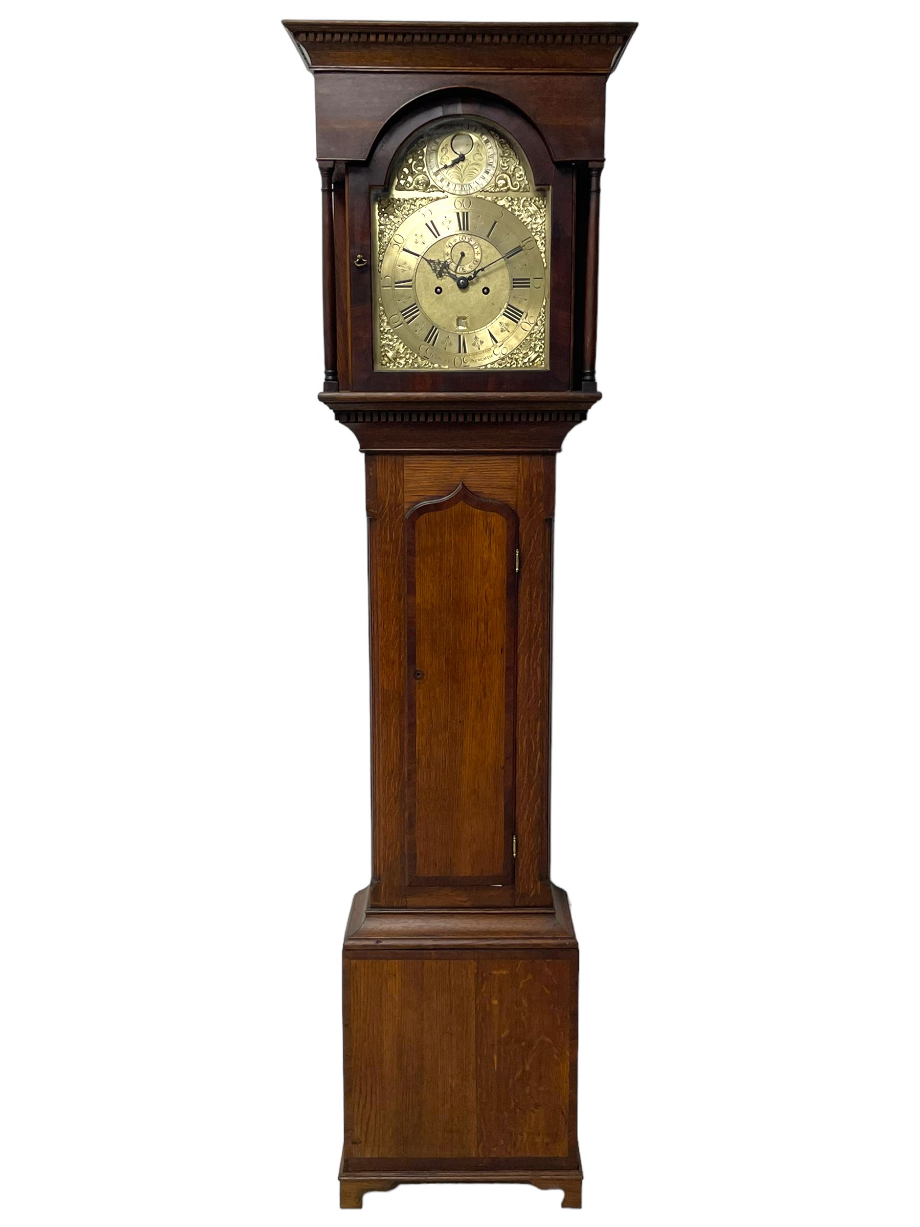 John Greaves of Newcastle - Mid-18th century 8-day oak longcase clock with a flat top, double cornice and break arch hood door flanked by two turned pilasters, trunk with canted corners and a spire topped door with crossbanding, rectangular plinth raised on bracket feet, brass dial with cast spandrels and penny-moon dial and pointer to the arch, matted dial centre with a silvered chapter ring and seconds ring, chapter with Roman numerals, five minute Arabic's, minute and quarter tracks, square date aperture and fettled steel hands, dial pinned to a rack striking movement with a recoil anchor escapement. With pendulum and weights.
