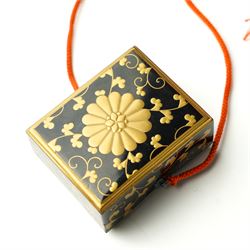 Japanese Meiji period lacquerware box with maki-e decoration, decorated centrally with the Chrysanthemum Seal, each side with trailing foliate decoration, the internal body with nashiji lacquer, with note reading 'From Prince Fushimi [Sadanaru] of Japan - May 1907', 5.5cm x 4.5cm
Provenance: Prince Sadanaru Fushimi of Japan visited London in May 1907, to be made an Honorary Member of the Military Division of the First Class by King Edward VII. The great-uncle of the vendor, by repute, worked in the Royal Household at this time, starting at age 15. It is unclear how he came to acquire the item, however it is known that he worked closely with Edward VIII. He would serve the family until his retirement, where he would be granted a grace-and-favour home on the Sandringham estate. Lot 6009, the cigarette case, is also property of the same vendor. 