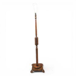 Late Victorian set of two oak standard lamps, turned and carved column supports, one with foliate carved panelled stem, on stepped square bases with carved scroll feet, the other on circular moulded spreading base