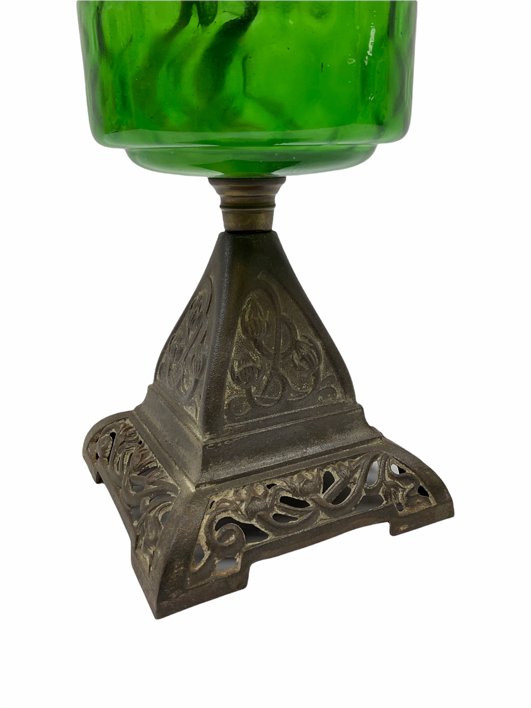 Late Victorian oil lamp, the cast metal base decorated with foliate tendrils, supporting a green glass reservoir, and opaque glass shade and clear class chimney, H60cm. 