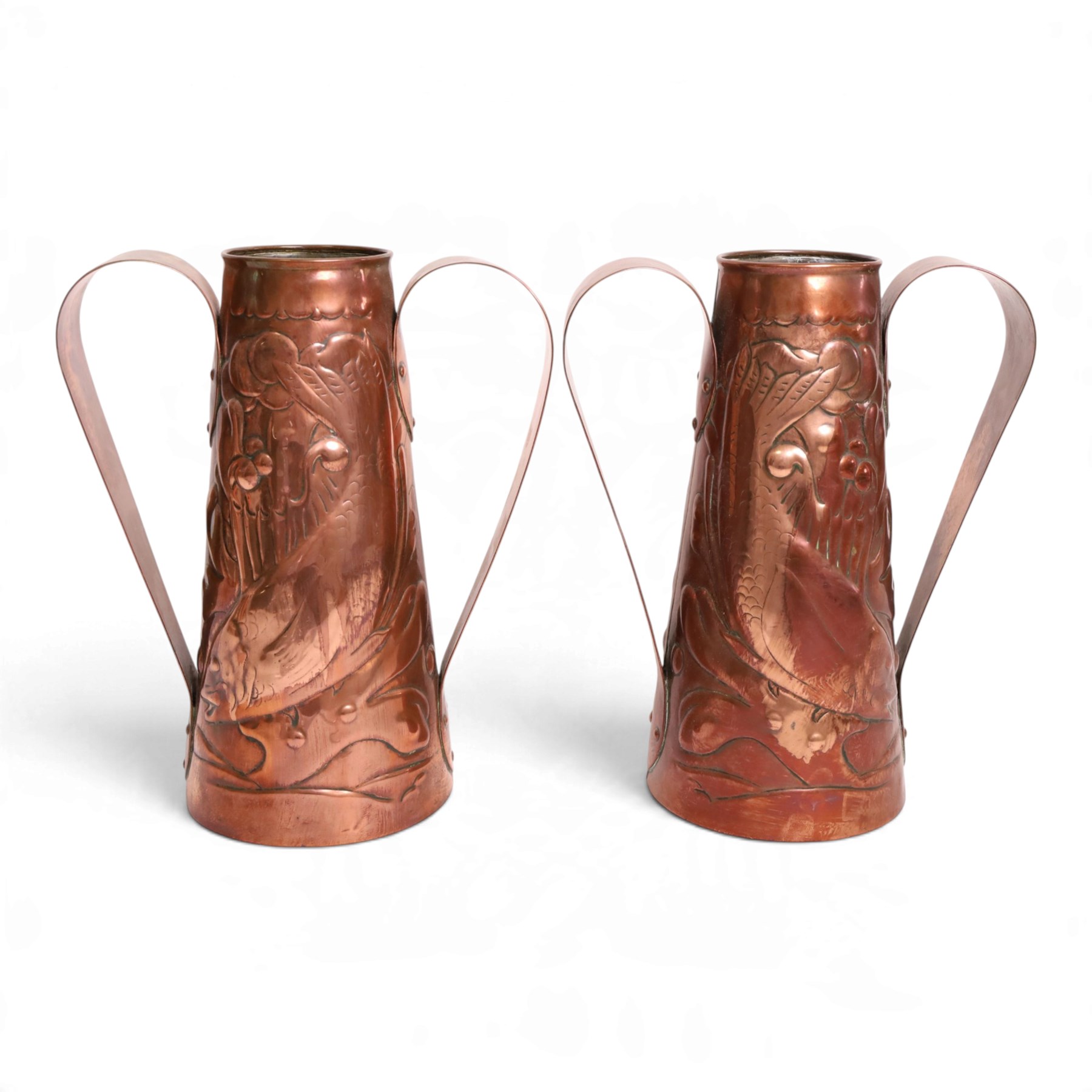 Pair of Newlyn Arts and Crafts copper twin handled vases, ff tapered form, repousse decorated with fish amongst seaweed, one with maker mark beneath, H25cm