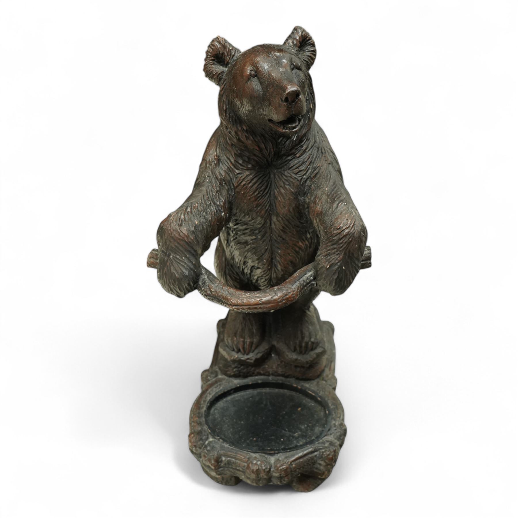 Early 20th century Black forest bear design stick stand, composite wood model of a bear with arms outstretched holding a branch forming the stick stand above a drip tray on tree branch form feet 