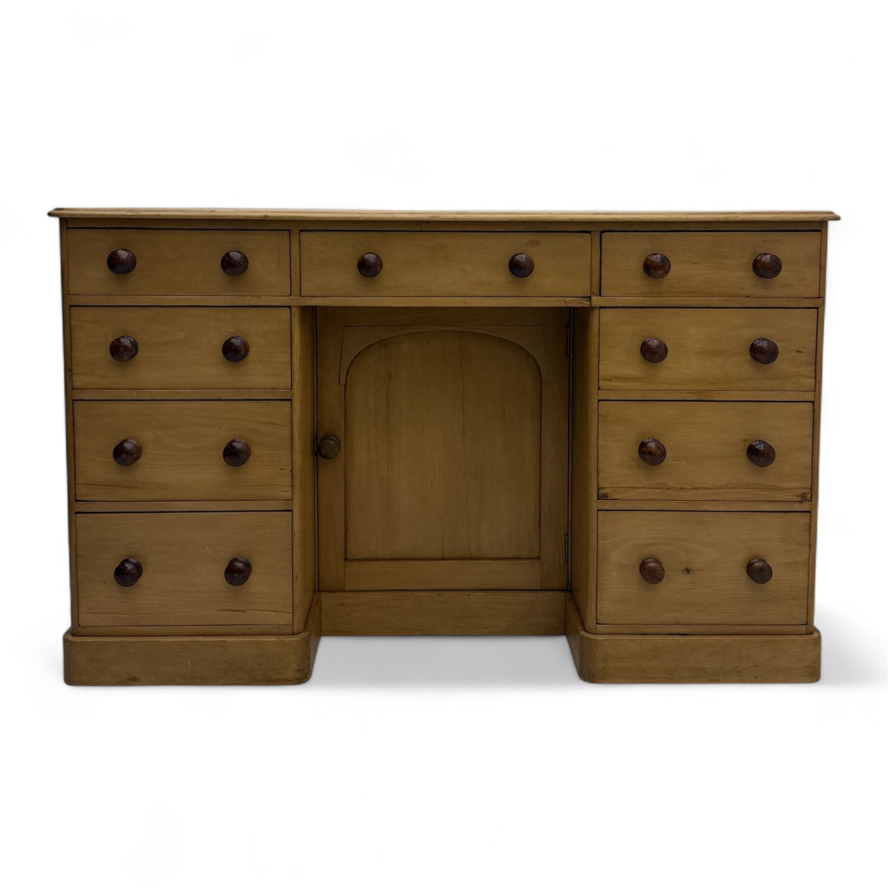 Late 19th-century Victorian stripped pine twin pedestal kneehole dressing table, the rectangular top above three short and three graduated drawers on each pedestal and a central cupboard, on a moulded plinth base 