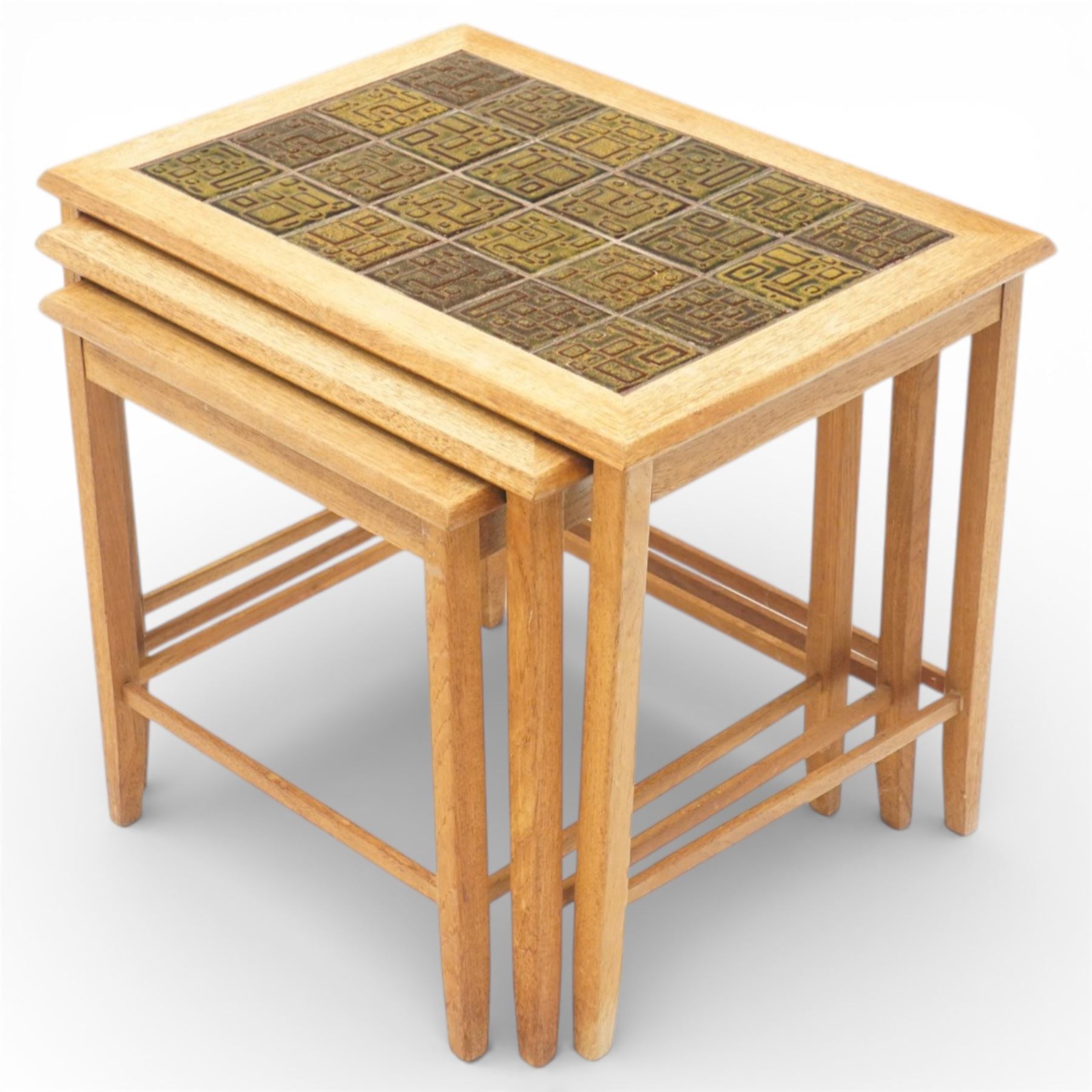 Mid 20th century Danish teak nest of three tables, rectangular tops inset with green geometric ceramic tiles within moulded frames, on square tapering supports united by stretchers