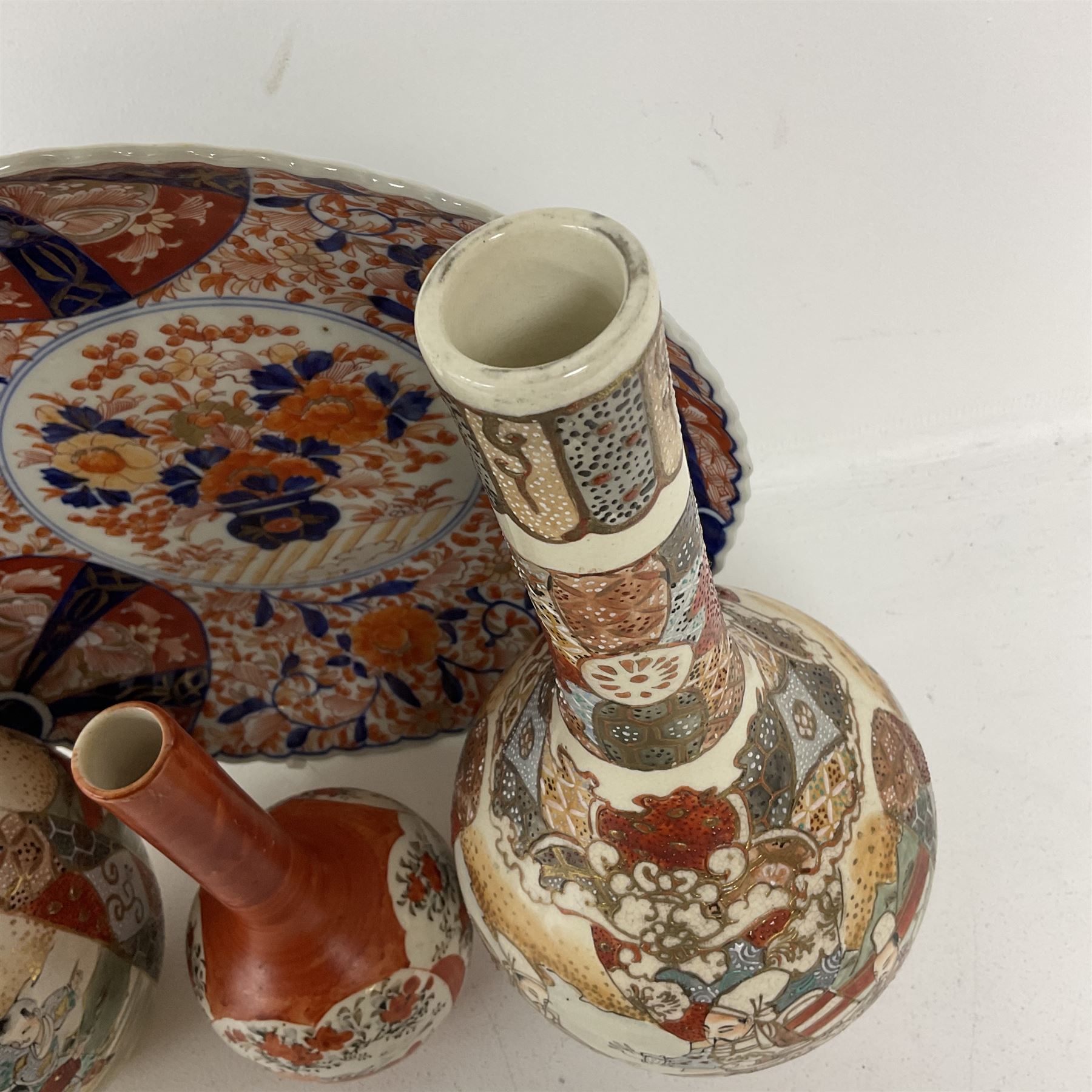 Collection of Japanese ceramics comprising pair of Satsuma vases decorated with panels depicting children and samurai figures, together with a Kutani vase painted with birds and flowers, all with painted character marks beneath, and an Imari plate, largest vase H31cm