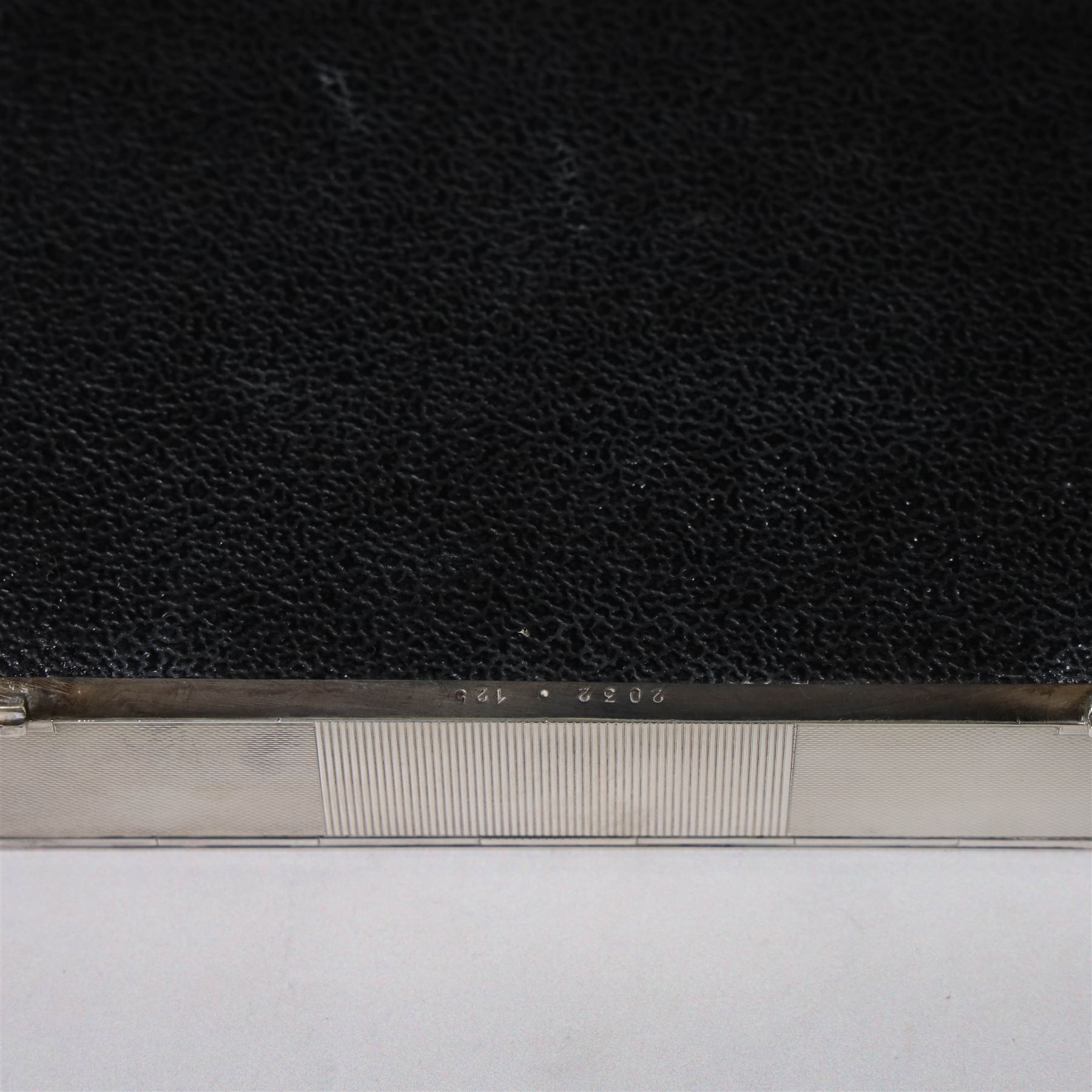 1960s silver mounted cigarette box, of rectangular form with engine turned decoration, upon four bracket feet, with presentation engraving to interior lid reading  'British Aircraft Corporation (Operating) Limited Commemorating the Queen's Award to Industry 1967, hallmarked James Geraghty, Birmingham 1965, with retailers mark for Asprey, W16.5cm, H4.5cm