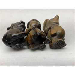 Seven netsuke, modelled as a tiger, pig, cat in a hat, rhino, mythical creature, bear in a hat and a tiger