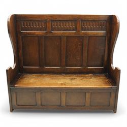 18th century design oak hall bench or settle, tall panelled back decorated with carved arcade, on two shaped end supports, hinged box seat opening to reveal a storage compartment, on a panelled base