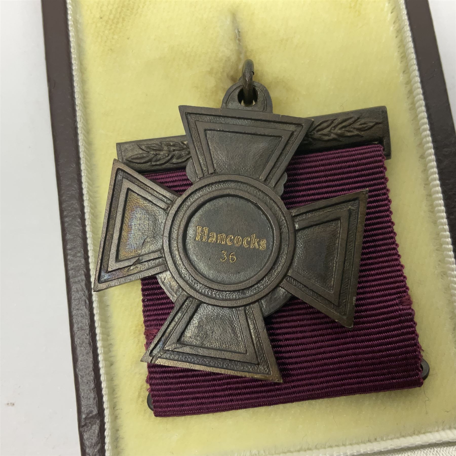 Victoria Cross, an official Hancocks & Co, London replica, the reverse engraved 'Hancocks 36', in fitted leather case of issue; Auctioneer's Note: The Victoria Cross was instituted on 29th January 1856, with the first awards backdated to 1854, and in the first 150 years of its existence was awarded on 1,355 occasions (1,352 Crosses and 3 Second Award Bars). To mark the 150th Anniversary, the London jewellers Hancocks, who have manufactured every Victoria Cross ever awarded, issued a limited edition replica, the replicas all individually numbered on the reverse, with the edition limited to 1,352 replica crosses. The No.36 apparently relates to actions by Capt. A. Henry of the Land Trans Corps at Inkerman 5/11/54 reported in the London Gazette 24/02/57.