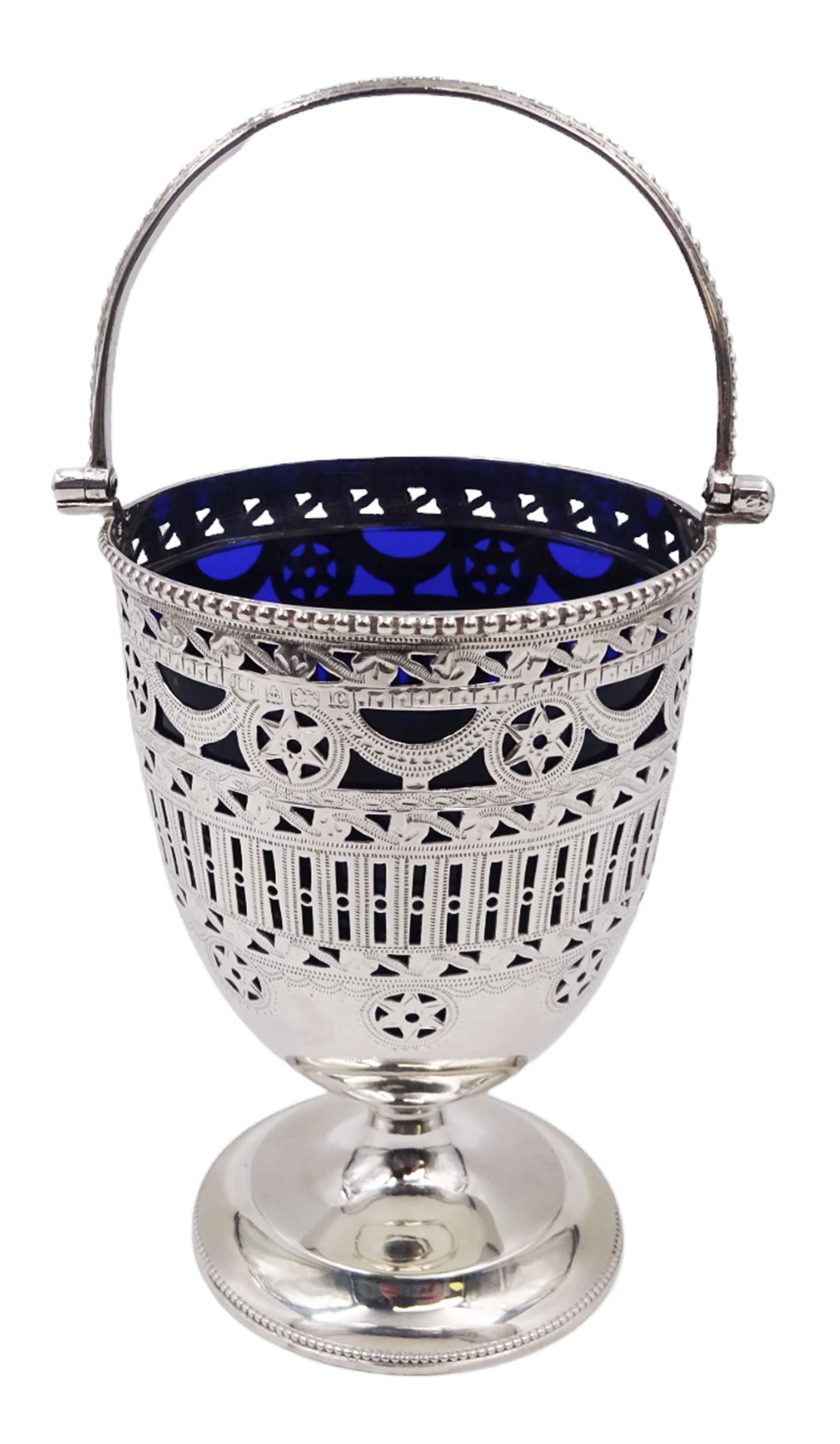 Edwardian silver swing handled sugar basket, with pierced and engraved star and foliate decoration to body, with beaded rim and handle, upon stepped circular base, hallmarked Thomas Hayes, Birmingham 1902, not including handle H10.8cm, with blue glass liner