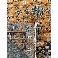 Small Persian rug/mat, blue and orange ground, decorated with stylised flower heads and geometric motifs 