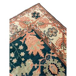 Persian emerald green ground rug, the field decorated with large stylised plant motifs, ivory ground border with repeating leaf motifs, the guards decorated with trailing branch and flowerhead motifs
