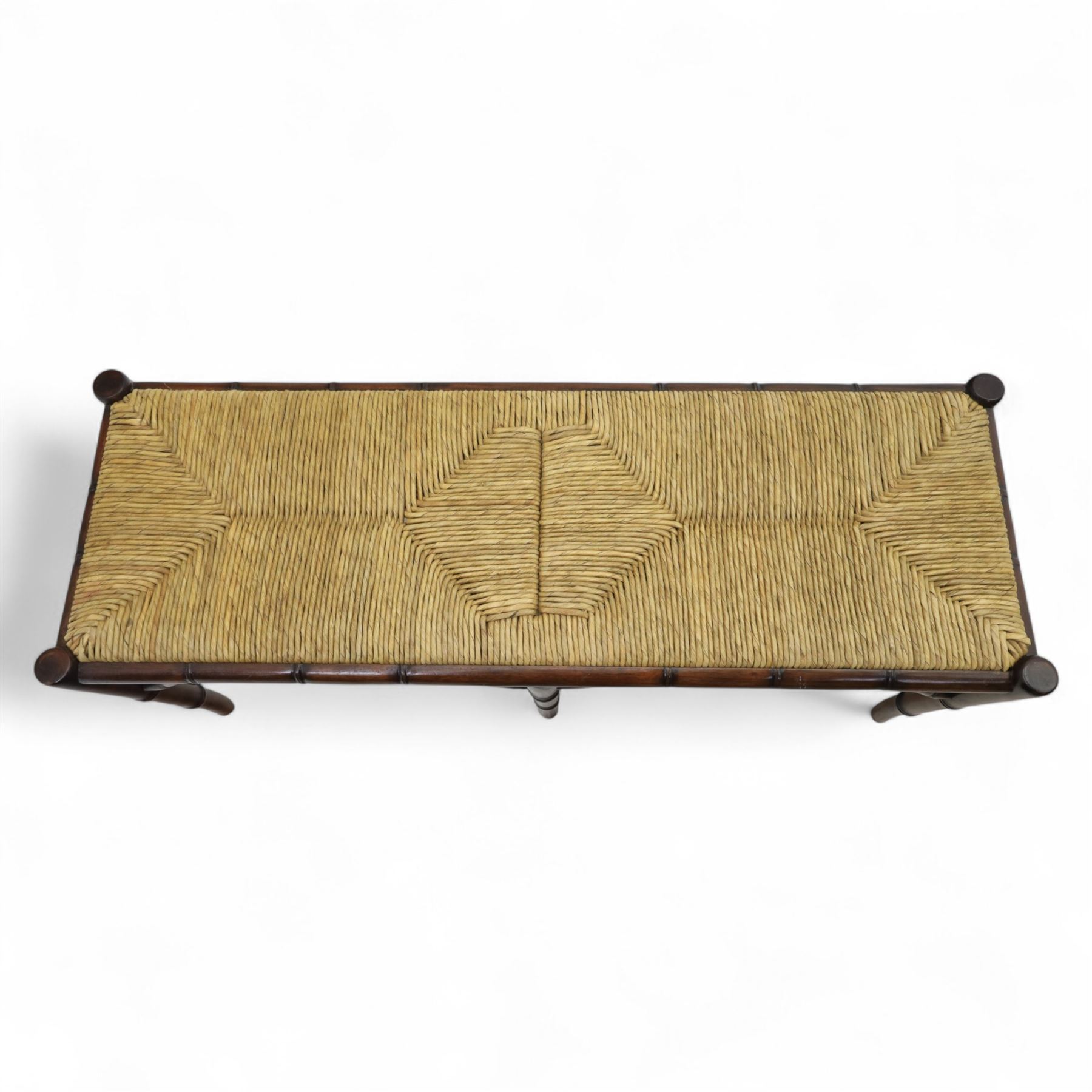 Faux bamboo long stool, stained beech frame with rectangular rush woven seat, rounded rail sides over ring-turned supports, united by side and end stretchers