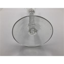 Two 18th century drinking glasses, the first example with ogee shaped bowl upon a double series opaque twist stem and conical foot, the second with round funnel bowl upon a single series air twist stem and conical foot, each approximately H15cm