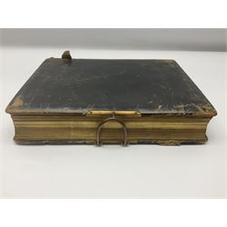  Victorian leather bound photo album, the interior leaves containing apertures of various sizes and shapes of portraits surrounded by printed floral designs, with brass clasp and painted gold decoration to edges, H30cm