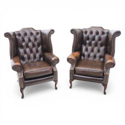 20th century Chesterfield style brown leather wingback armchairs, with button upholstered ...