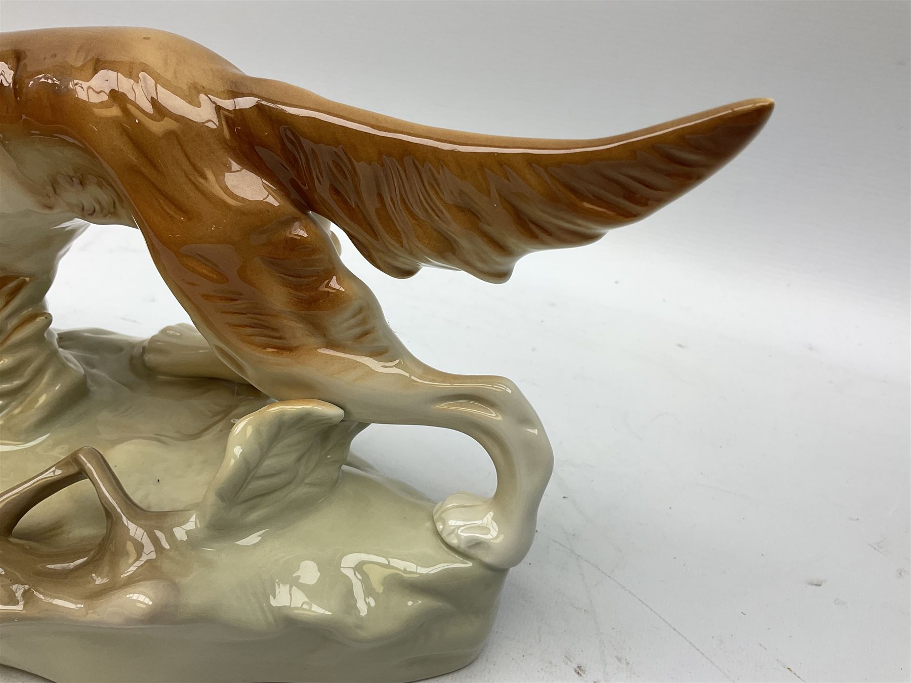 Royal Dux porcelain hunting dog with a bird, printed mark beneath, L36cm