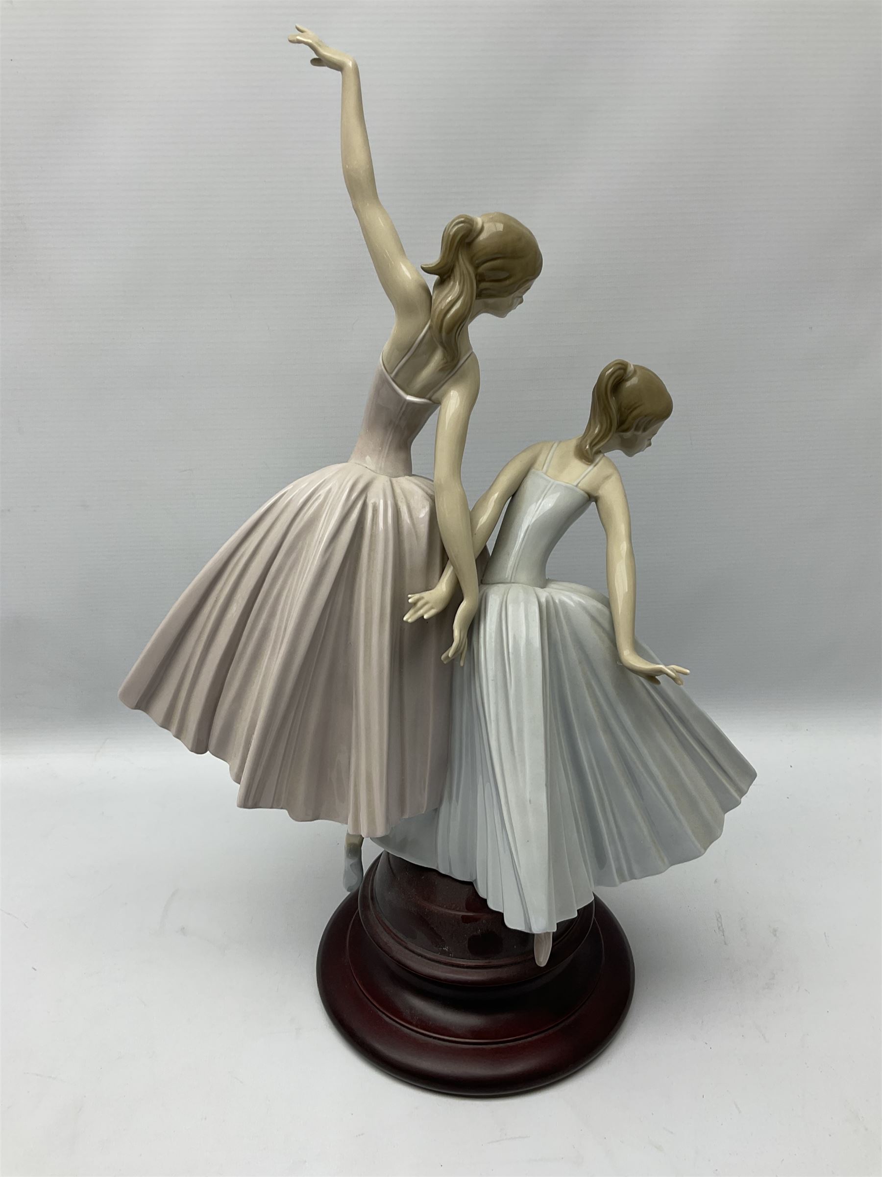 Lladro figure group, 'Merry Ballet', modelled as two ballerinas in dancing pose, raised on a turned socle base, no. 5035, printed marks beneath, H49cm