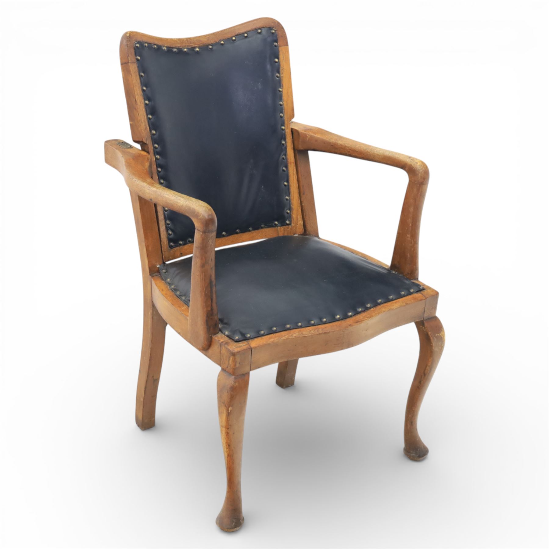 20th century oak recliner armchair, the curved back upholstered in leather with brass stud edging, hinged reclining back operated by side ratchet fittings, leather upholstered seat, shaped open arms, raised on cabriole legs