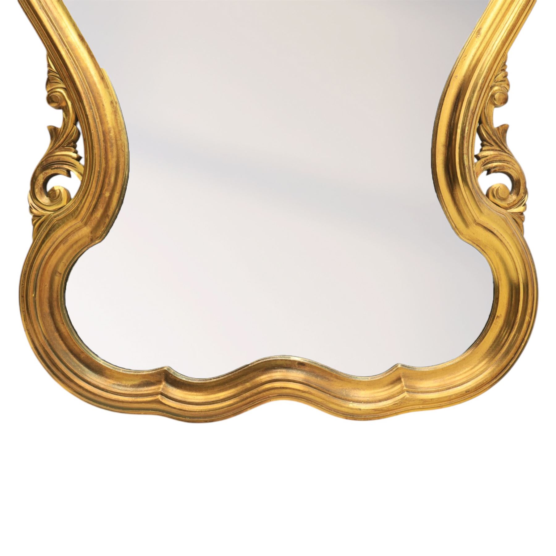 Rococo design gilt wall mirror, shaped and moulded frame, serpentine lower apron, enclosing a plain mirror 