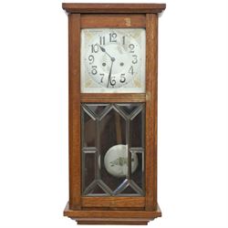 Art Deco style oak wall clock, moulded cornice above a silvered dial with Arabic numerals ...