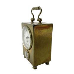 French - petite early 20th century French brass cased travelling alarm clock, with bun feet and carrying handle, circular enamel dial with Arabic numerals and spade hands, conforming alarm setting dial beneath, with a platform escapement, wound and set from the rear.