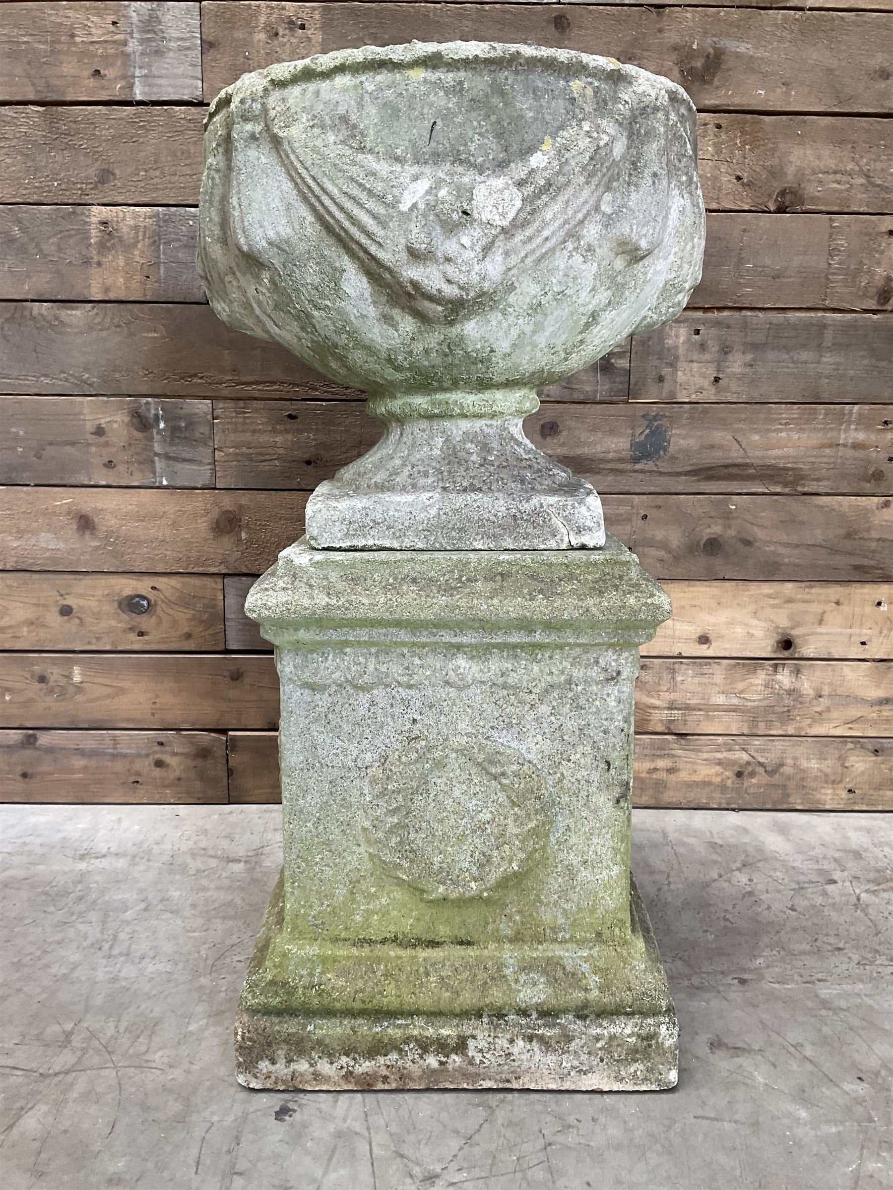 Cast stone centerpiece urn on plinth