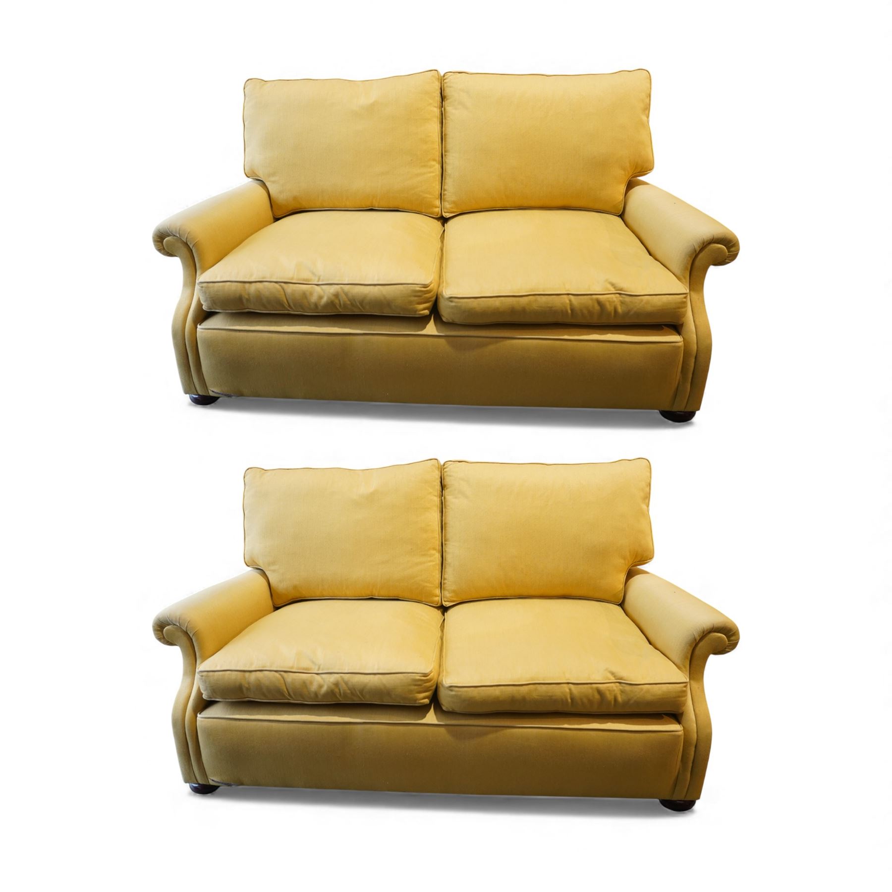 Pair of mid-20th century traditional two seat sofas, loose cushioned seat and back upholstered in pale gold fabric, on turned supports