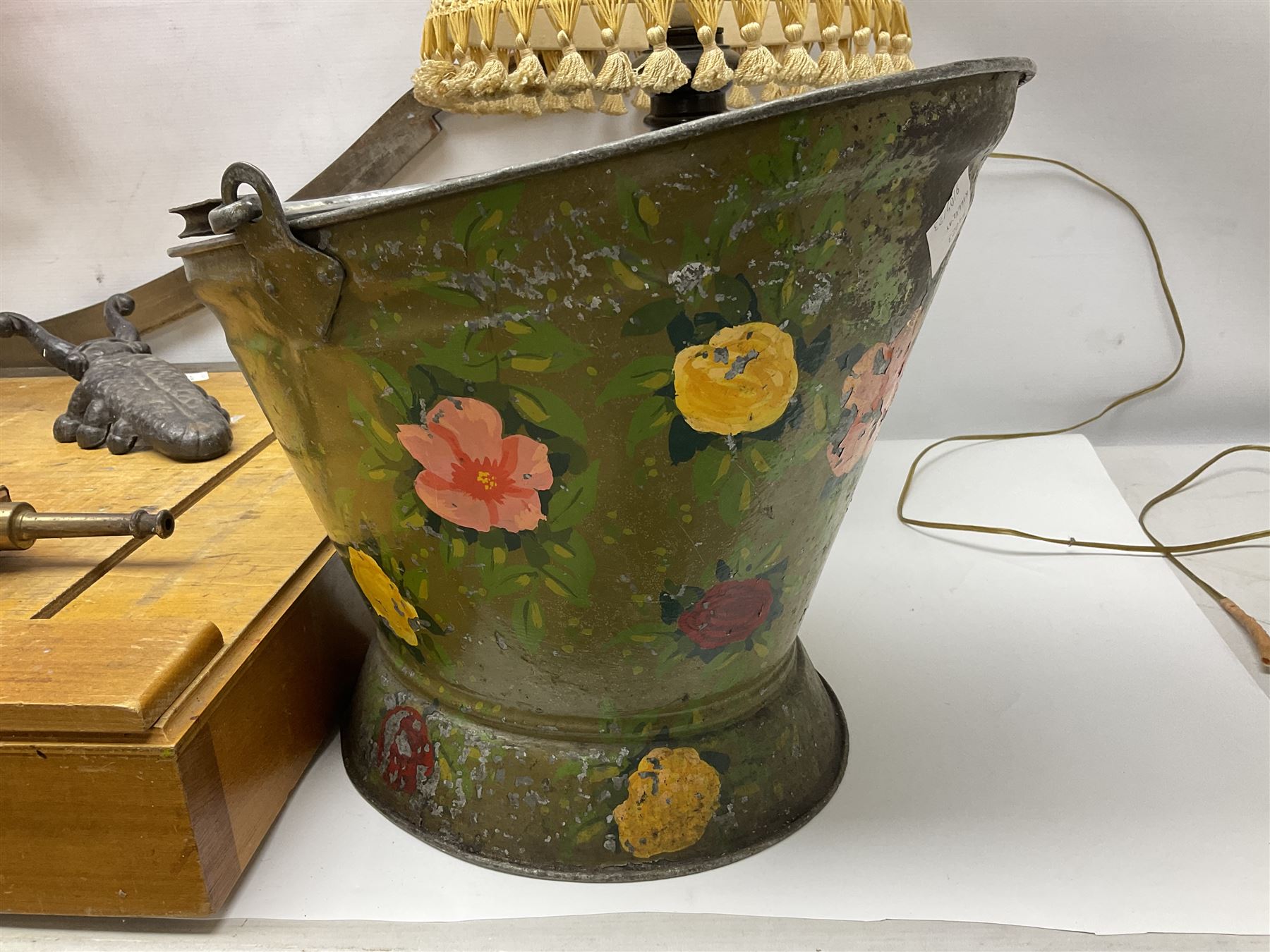 Coal bucket painted with flowers together with pair of bellows, boot scraper in the form of a beetle, wooden guillotine, composite table lamp with tassel lampshade and one other
