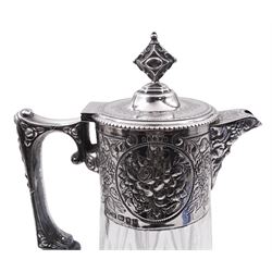 Modern silver mounted cut glass claret jug, in the Victorian style, the tapering cylindrical body with foliate embossed collar, Bacchus mask spout, conforming mask and foliate detail to angular scroll end handle, and hinged cover, hallmarked London 1994, makers mark W W, H27.5cm