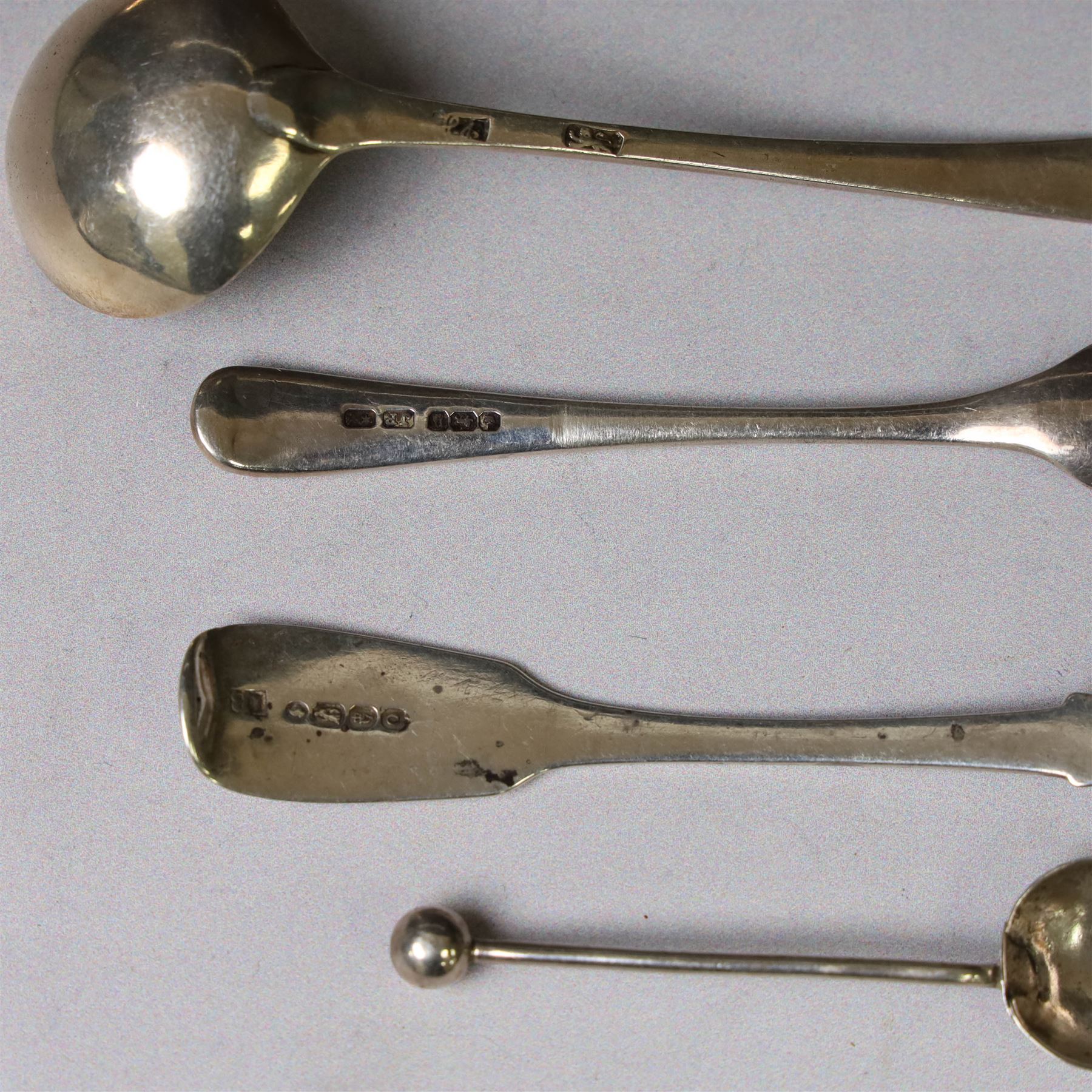 George III silver marrow scoop, hallmarked London 1767, makers mark indistinct, together with a collection of silver condiment spoons and butter knives, all hallmarked