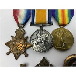 Made-up group of three WWI medals comprising 1914 Star awarded to 23598 Gnr. F. Jefferson R.G.A., British War Medal and Victory Medal with names removed; with ribbons on wearing bar; 1942 Motorist's Medal and small quantity of cap badges, Royalty badges etc