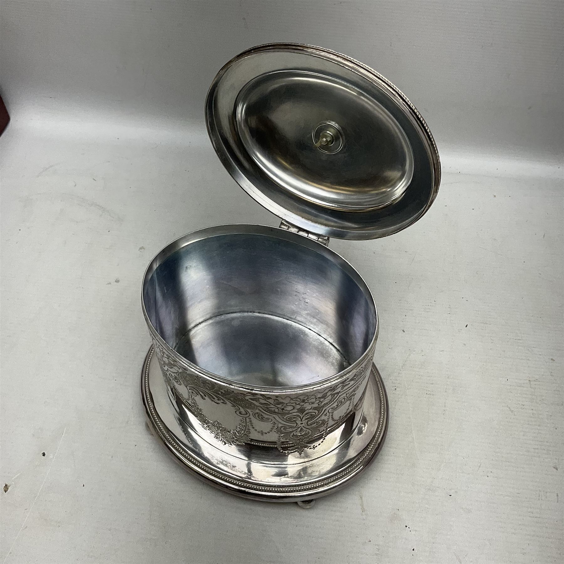 Late Victorian silver-plated biscuit barrel by William Hutton & Sons, on integral stand with four bun feet and ornate foliate engraved decoration, H20cm