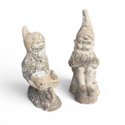 Two seated cast stone garden gnomes