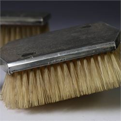 Mid 20th century silver mounted dressing table set, comprising hair brush, clothes brush, hand mirror and comb, each with engine turned Art Deco style decoration, all hallmarked Walker & Hall, Sheffield 1954 &1955