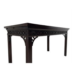 In the manner of Thomas Chippendale - early 19th century mahogany serving table, rectangular crossbanded top with boxwood stringing, the frieze with upper moulding over applied geometric fretwork, the left-hand side fitted with slide, on fluted square supports with inner chamfer 